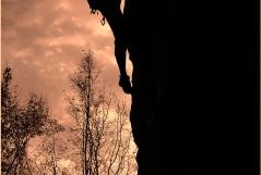 man climbing rock