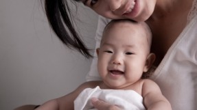 asian mother holding baby